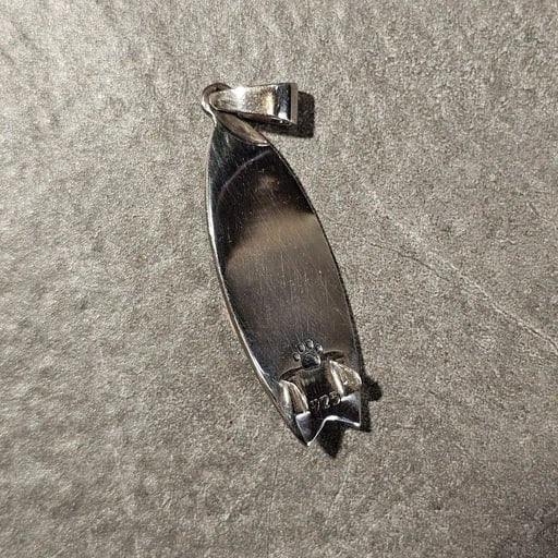 Back side of handcrafted sterling silver fish surfboard pendant with 925 stamp – Barong surf jewelry by Snow Cat Jewelry