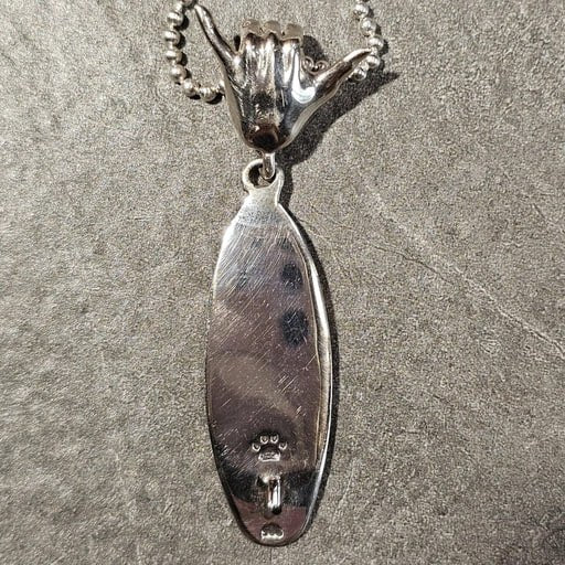 Back side of sterling silver surfboard pendant with Shaka hand bail – Ocean Spirit necklace by Snow Cat Jewelry