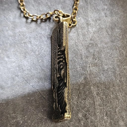 Brass Buddha Gaze pendant with detailed relief design symbolizing wisdom and inner peace – handcrafted spiritual jewelry by Snow Cat
