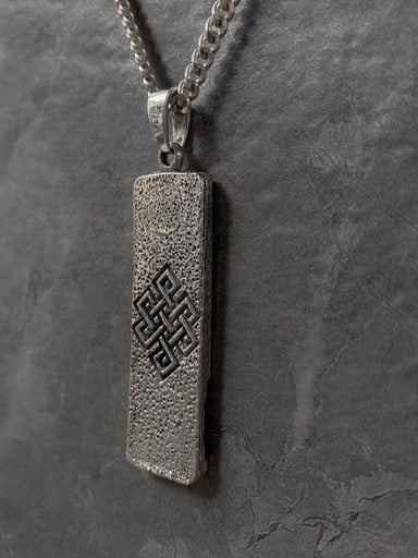 Sterling silver Buddha pendant featuring the endless knot symbol on the back – spiritual jewelry by Snow Cat Jewelry