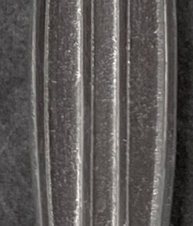 Macro view of sterling silver surf longboard pendant with vertical grooved design – handcrafted ocean jewelry by Snow Cat Jewelry