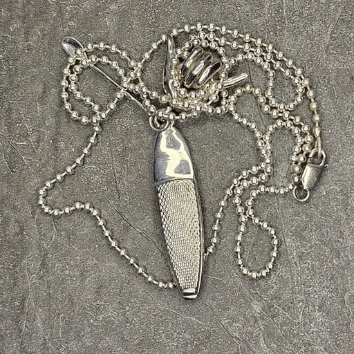 Sterling silver necklace with SUP paddleboard pendant and Shaka hand bail shown coiled with chain – handcrafted surf jewelry by Snow Cat Jewelry