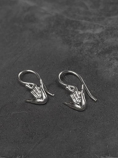 925 sterling silver Shaka gesture earrings on dark stone surface – minimalist surf jewelry by Snow Cat Jewelry