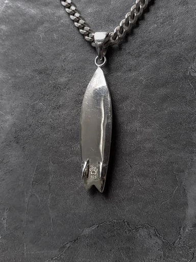 Back view of Fish Surfboard pendant in 925 sterling silver with coral wax-style engraving and tail fins – handcrafted surf charm by Snow Cat Jewelry
