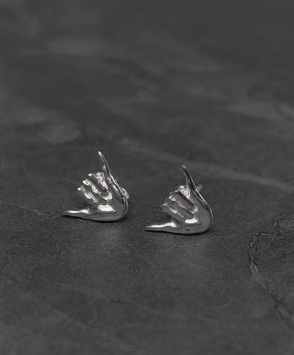 Side angle view of Shaka hand stud earrings in 925 sterling silver – surf-style unisex jewelry by Snow Cat Jewelry
