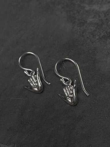 Pair of silver Shaka gesture earrings crafted from 925 sterling silver, front view on dark background – surf-inspired jewelry by Snow Cat Jewelry